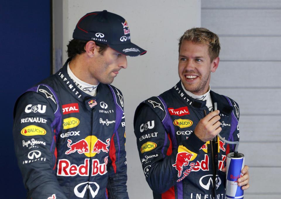 Red Bull Formula One driver Sebastian Vettel of Germany (R) smiles at teammate Red Bull Formula One driver Mark Webber of Australia after the qualifying session for the Korean F1 Grand Prix at the Korea International Circuit in Yeongam, October 5, 2013. Formula One championship leader Vettel will start Sunday's Korean Grand Prix on pole position for Red Bull with Lewis Hamilton's Mercedes alongside on the front row. REUTERS/Kim Hong-Ji (SOUTH KOREA - Tags: SPORT MOTORSPORT F1 TPX IMAGES OF THE DAY)