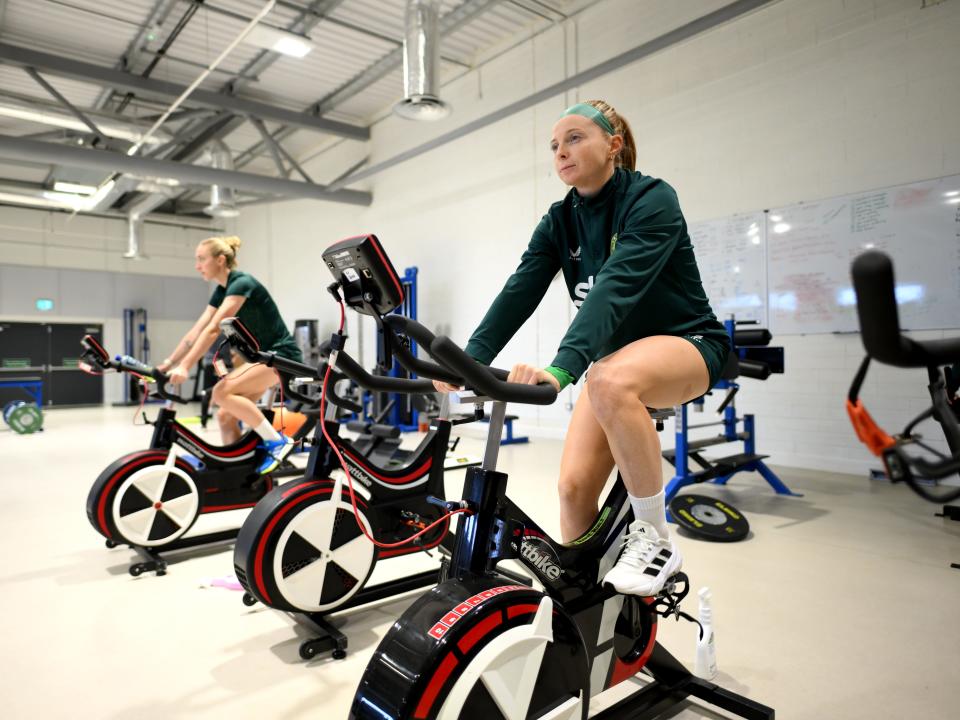 Women on the Republic of Ireland's women's national team riding stationary bikes.