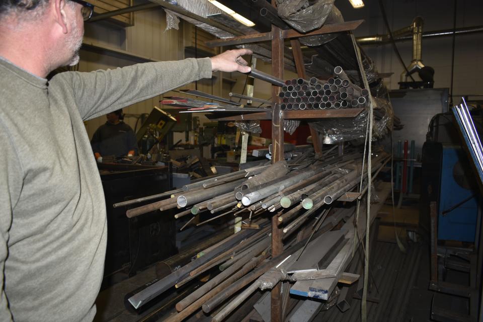 Hoosier Hills Career Center welding technology teacher Mark Scranton points to metal donated to the school for students to use as class materials.