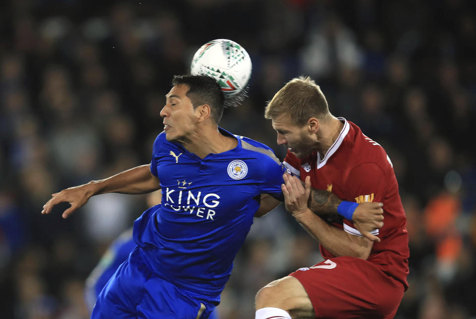 Leicester City’s Leonardo Ulloa, left, and Liverpool’s Ragnar Klavan battle for the ball