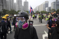 In this Aug. 16, 2019, photo, Wayne, a 33-year-old self-described “front line” protester, stands along with other demonstrators in Tai Po, on Hong Kong's outskirts. Hong Kong's protest movement has reached a moment of reckoning after protesters occupying the airport held two mainland Chinese men captive, and pro-democracy lawmakers and fellow demonstrators question whether the whole operation has gone too far. (AP Photo/Vincent Thian)