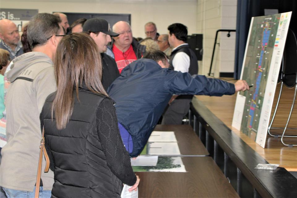 Pleasant Township residents look at a map of the proposed site of the Chestnut Solar LLC solar energy facility during a public meeting on Tuesday, Dec. 6, 2022, at Tri-Rivers Career Center.