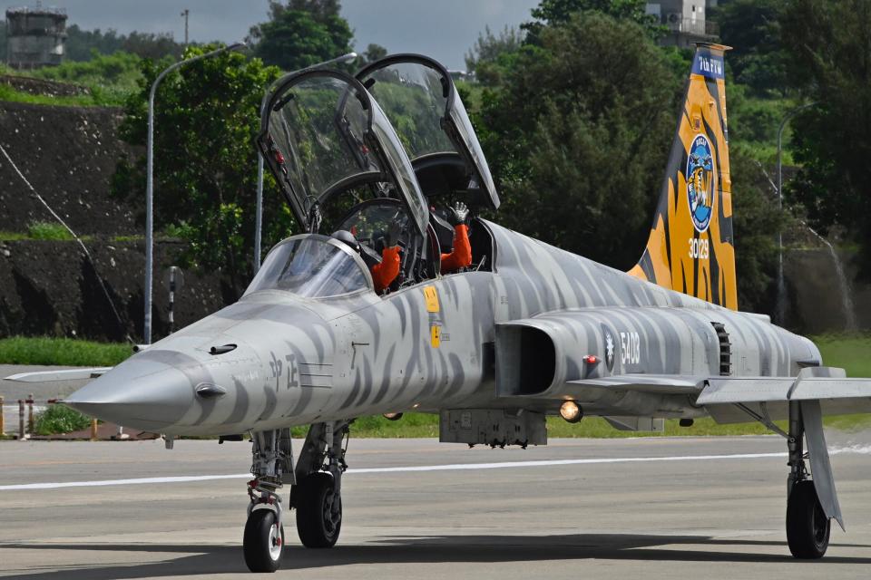 Pilots aboard a ROCAF F-5F wave to journalists during a demonstration at Chihhang Air Bas<em>e</em>, eastern Taiwan, on July 6, 2022. <em>Photo by SAM YEH/AFP via Getty Images</em>