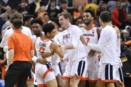 Mar 30, 2019; Louisville, KY, United States; Virginia Cavaliers guard Kihei Clark (0) and teammates celebrate the win over Purdue Boilermakers in overtime in the championship game of the south regional of the 2019 NCAA Tournament at KFC Yum Center. Mandatory Credit: Jamie Rhodes-USA TODAY Sports