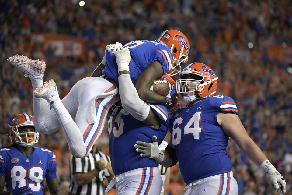 Florida wide receiver Van Jefferson (12) celebrates with wide receiver Tyrie Cleveland (89), offensive lineman Jawaan Taylor (65) and offensive lineman Tyler Jordan (64) after catching a pass in the end zone for a 6-yard touchdown during the first half of an NCAA college football game against the Charleston Southern Saturday, Sept. 1, 2018, in Gainesville, Fla. (AP Photo/Phelan M. Ebenhack)
