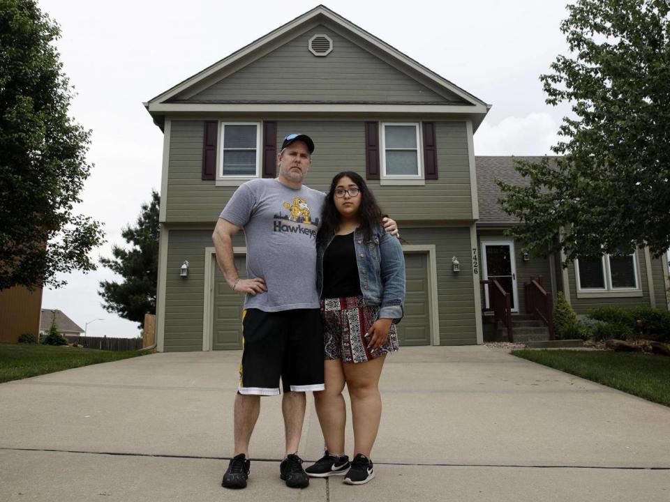 Jennifer Tadeo-Uscanga, 17, and her stepdad, Steve Stegall, stand outside their house in Kansas City, Missouri. Jennifer’s mother Letty Stegal lived in the United States for 20 years, but was deported back to Mexico in March. (AP Photo/Charlie Riedel)