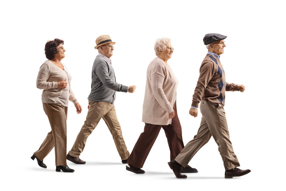 Group of elderly people walking isolated on white background