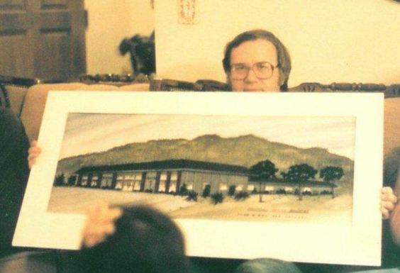 A 1980s photo shows KVVQ-FM founder Ken Orchard with a rendering of his new radio station in Hesperia.