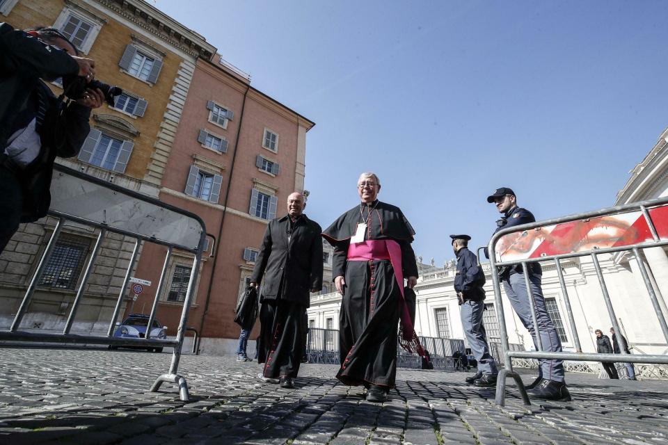 Cardinal Jean-Claude Hollerich, right, leaves at the end of the first day of a sex abuse within the Catholic church prevention summit, at the Vatican, Thursday, Feb. 19, 2019. Pope Francis opened a landmark sex abuse prevention summit Thursday by warning senior Catholic figures that the faithful are demanding concrete action against predator priests and not just words of condemnation (Giuseppe Lami/ANSA via AP)