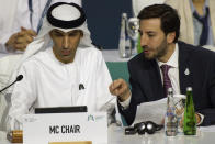 Emirati Minister of State for Foreign Trade Thani bin Ahmed al-Zeyoudi, left, works with World Trade Organization's Santiago Wills at a WTO summit in Abu Dhabi, United Arab Emirates, Monday, Feb. 26, 2024. The World Trade Organization opened its biennial meeting Monday in the United Arab Emirates as the bloc faces pressure from the United States and other nations ahead of a year of consequential elections around the globe. (AP Photo/Jon Gambrell)