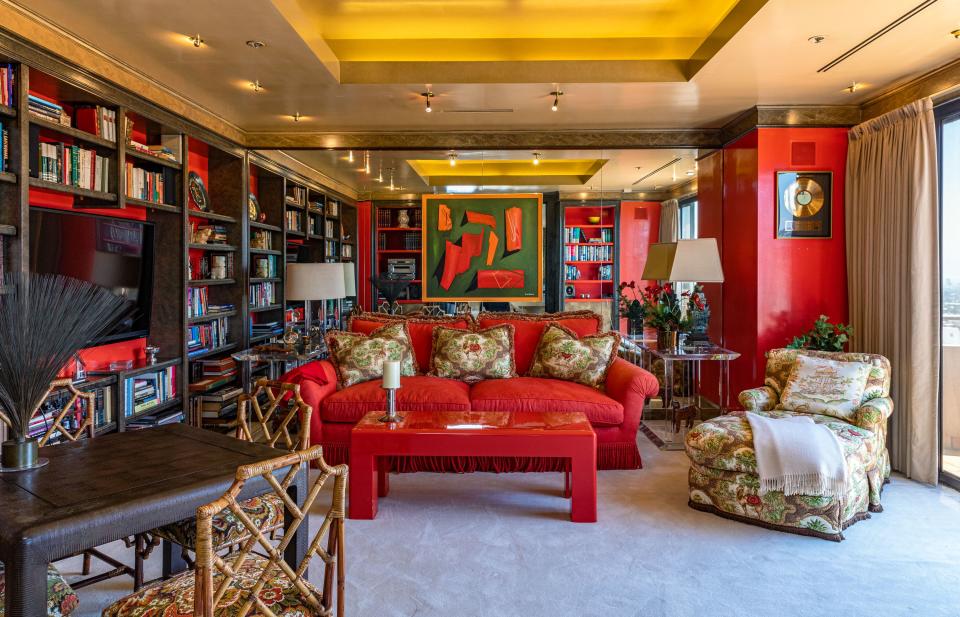 The apartment features a cozy red library.