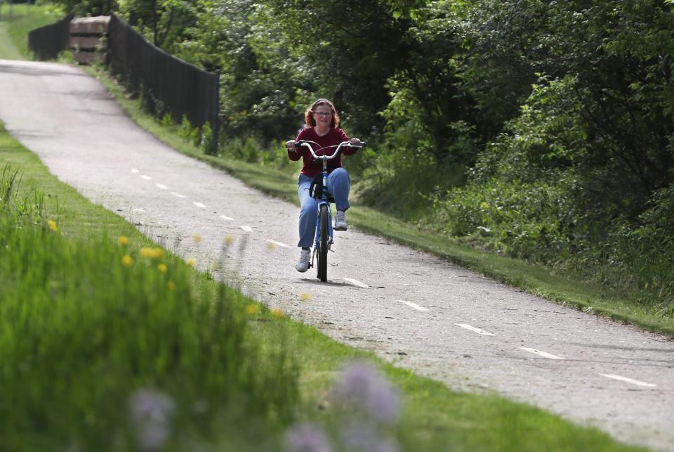 A bicyclist rides along the County Line Bike Trail in Rittman.