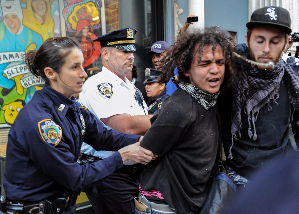 A person associated with the Occupy movement is arrested on a march down Broadway Street in New York enroute to Zuccotti Park, Saturday, Sept. 15, 2012. Monday marks the one year anniversary of the Occupy movement. (AP Photo/Stephanie Keith)