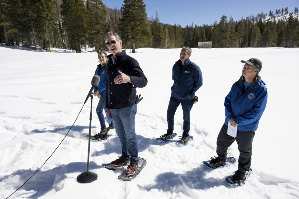 Gov. Gavin Newsom announces an updated California Water Plan with Department of Water Resources director Karla Nemeth, left, Natural Resources Secretary Wade Crowfoot, center, and DWR water resources engineer Andrew Reising during the April snow survey at Phillips Station in El Dorado County on Tuesday, April 2, 2024. (Paul Kitagaki Jr./The Sacramento Bee via AP, Pool)