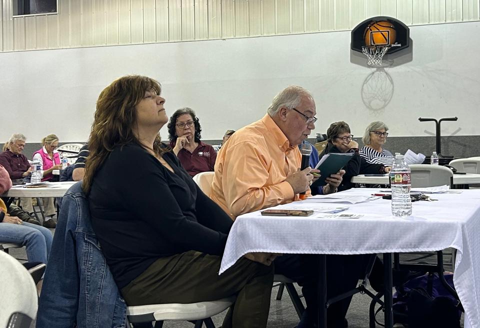 Heidi Policky sits next to Pastor Garry Martin as he moderates the school board forum on Feb. 20 in Jackson, Tenn.