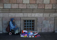 A woman sells towels and socks in Istanbul, Turkey August 10, 2018. REUTERS/Murad Sezer