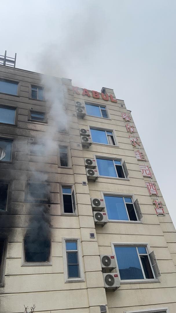 Smoke pours out of a window of a hotel in Kabul, Afghanistan, used by many Chinese nationals, during an attack on December 12, 2022. / Credit: Kabul Police