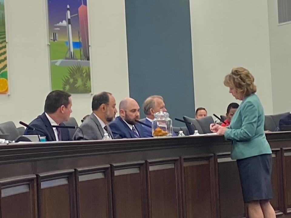 Members of the Senate Select Committee on Reapportionment discuss the results of a drawing for Senate district numbers with Secretary of the Senate Debbie Brown. Jan. 2022