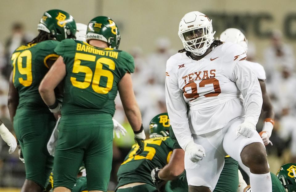 Texas defensive lineman T'Vondre Sweat celebrates a sack of Baylor quarterback Sawyer Robertson. Texas coach Steve Sarkisian said Sweat and fellow defensive tackle Byron Murphy II 'set the tone for the entire team.'