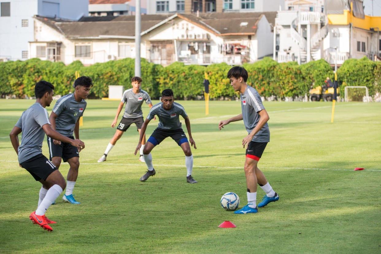 Singapore footballers training in a group. In Phase 3, the group size can be increased from five to eight.