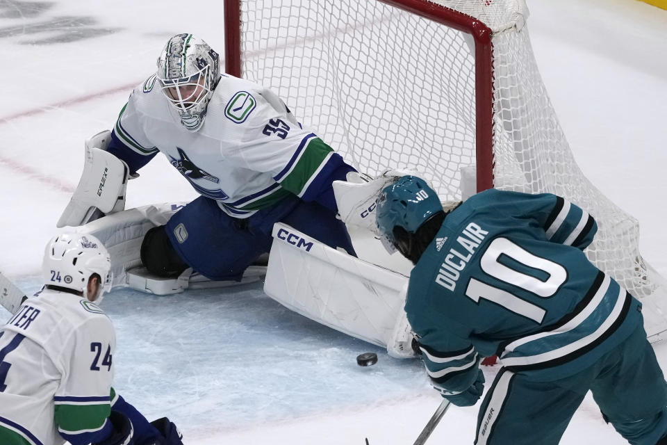 Vancouver Canucks goaltender Thatcher Demko (35) defends against a shot by San Jose Sharks left wing Anthony Duclair (10) during the third period of an NHL hockey game in San Jose, Calif., Thursday, Nov. 2, 2023. (AP Photo/Jeff Chiu)