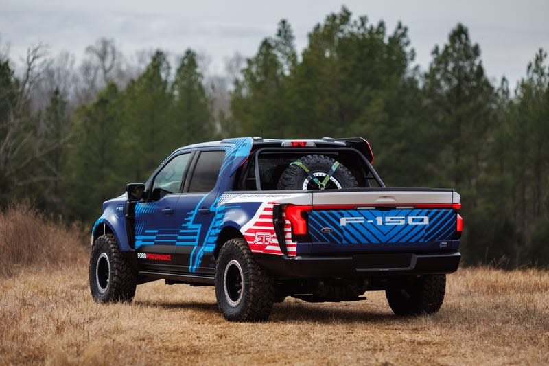 The off-road spec Switchgear from the rear 3/4 showing the custom bodywork and tire rack in the bed