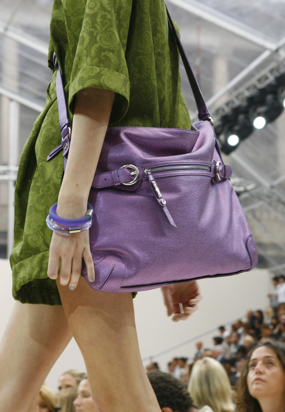 FILE - A model sports a purple handbag as part of the Moschino Spring/Summer 2008 collection presented in Milan, Italy on Sept, 25, 2007. (AP Photo/Alberto Pellaschiar, File)