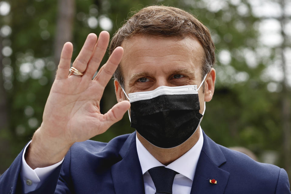 French President Emmanuel Macron waves during the first round of French regional and departmental elections, in Le Touquet-Paris-Plage, northern France, Sunday, June 20, 2021. The elections for leadership councils of France's 13 regions, from Brittany to Burgundy to the French Riviera, are primarily about local issues like transportation, schools and infrastructure. But leading politicians are using them as a platform to test ideas and win followers ahead of the April presidential election. (Christian Hartmann/Pool via AP)