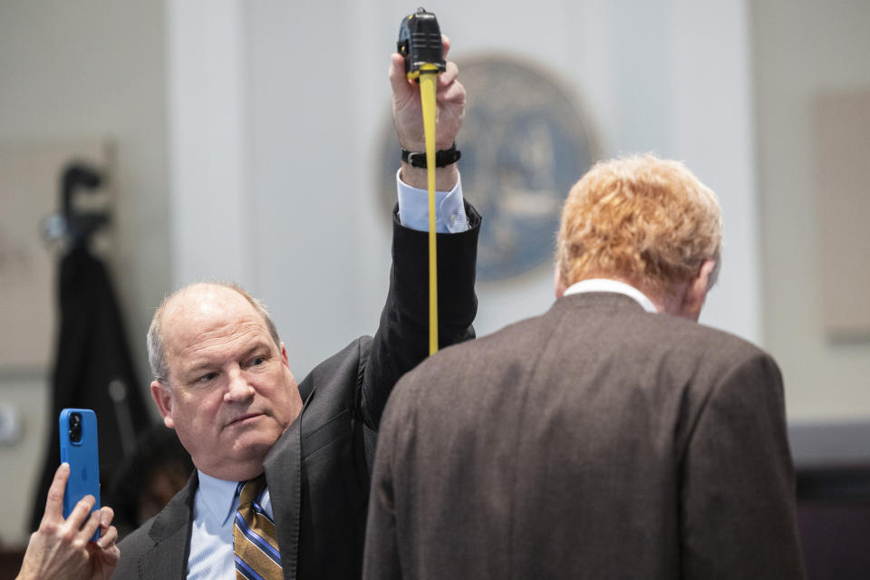 Defense attorney Jim Griffin measures Alex Murdaugh during a break in his double murder trial at the Colleton County Courthouse on Thursday, Feb. 16, 2023, in Walterboro, S.C. The 54-year-old attorney is standing trial on two counts of murder in the shootings of his wife and son at their Colleton County home and hunting lodge on June 7, 2021. (Joshua Boucher/The State via AP, Pool)