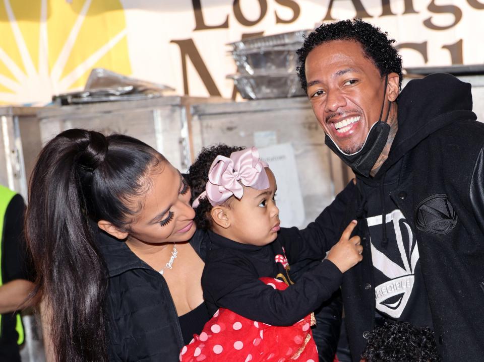 Brittany Bell, Nick Cannon and daughter Powerful Queen Cannon attend the Los Angeles Mission's Annual Christmas Celebration at the Los Angeles Mission on December 23, 2022.