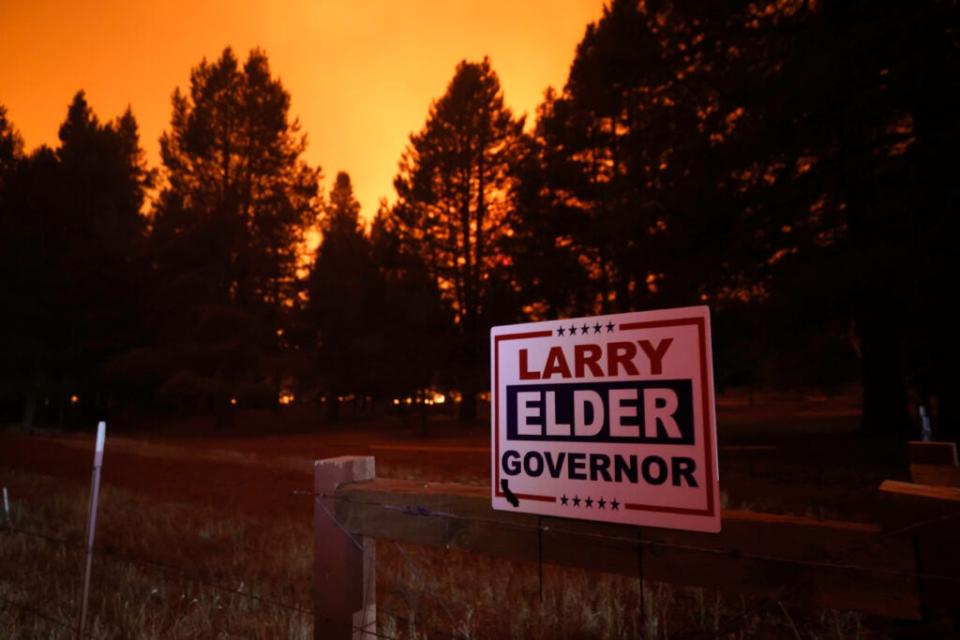 A campaign sign for Larry Elder is posted on a fence in front a home as the Caldor Fire moves through the area on August 30, 2021 near South Lake Tahoe, California. (Photo by Justin Sullivan/Getty Images)