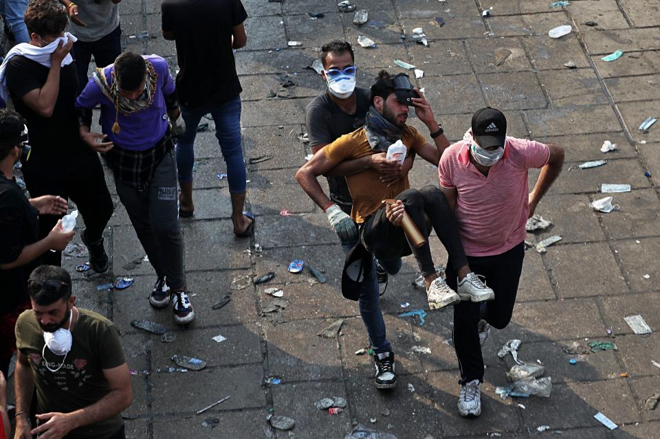 An injured protester is rushed to a hospital during an anti-government protest in Baghdad, Iraq, Tuesday, Oct. 29, 2019. Iraqis took to the streets for a fifth straight day after a hiatus in the demonstrations that began earlier this month to protest government corruption, a lack of jobs and municipal services, and other grievances. (AP Photo/Khalid Mohammed)