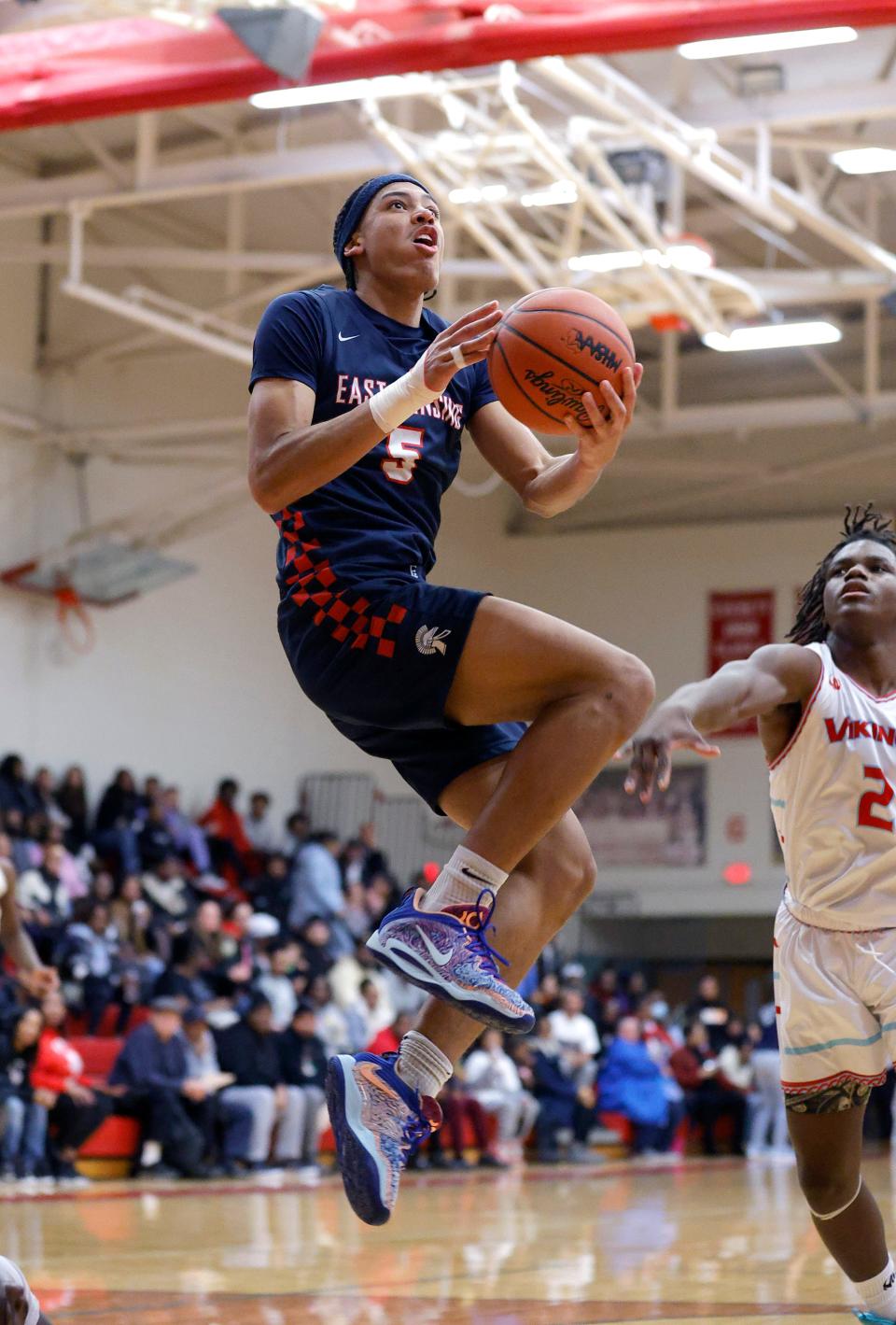 East Lansing's Cam Hutson goes up for a shot against Everett's Javari Funches, Tuesday, Dec. 19, 2023, in Lansing.