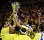 Maccabi of Tel Aviv captain Maccabi Guy Pnini, right, and his teammate Maccabi Tel Aviv's Alex Tyus hold the trophy as they celebrate with teammates after winning the Euroleague Final Four final against Real Madrid in Milan, Italy, Sunday, May 18, 2014. (AP Photo/Luca Bruno)