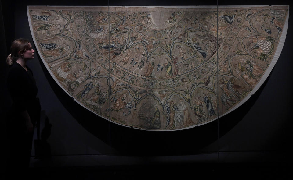 <p>A museum employee views The Bologna Cope dating from the fourteenth century which forms one of a large collection of rare pieces brought together from around Europe for the forthcoming exhibition ‘Opus Anglicanum: Masterpieces of English Medieval Embroidery’ at the Victoria and Albert Museum in London, Britain, Sept. 28, 2016. (Photo: Toby Melville/Reuters) </p>