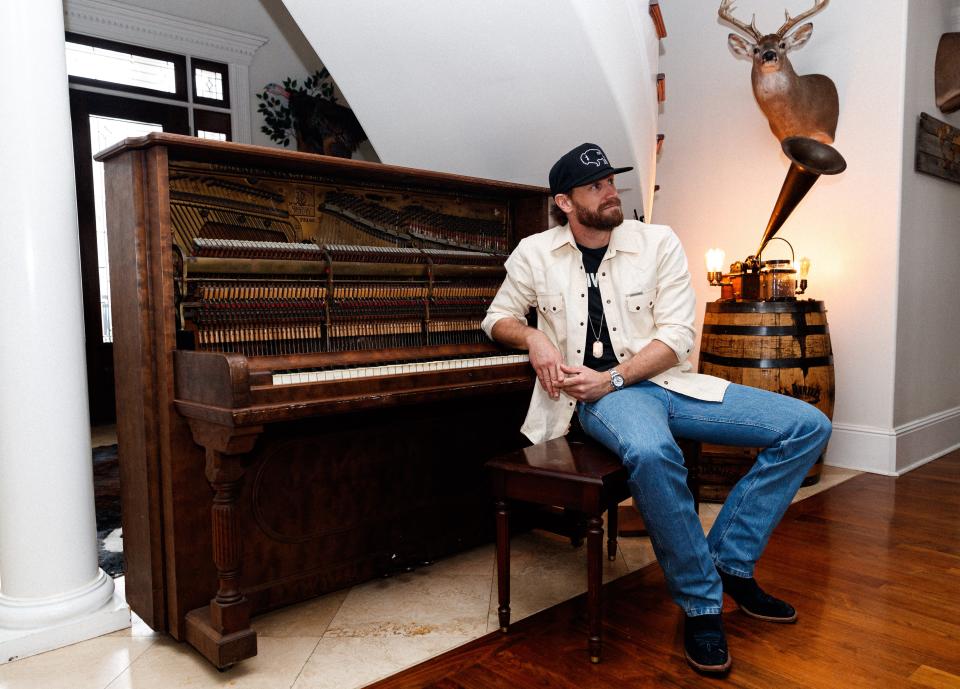 Chase Rice sits at his piano, affectionately named "Old Girl," in his home where he recorded his latest album "I Hate Cowboys & All Dogs Go To Hell" in Franklin, Tenn. on Feb. 1, 2023. Chase purchased the piano solely to record his latest record with it.