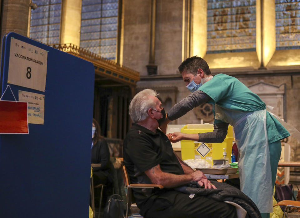 Lynn Court receives an injection of the Pfizer coronavirus vaccine from Dr Ben Kay at Salisbury Cathedral, Wiltshire.PA