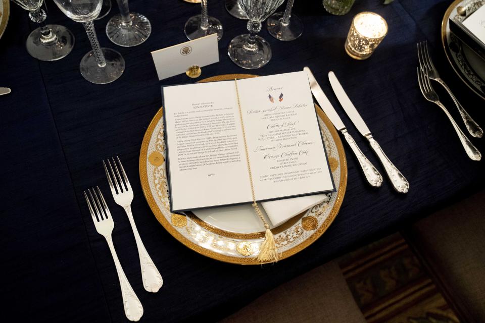 A table is set during a media preview for the State Dinner with President Joe Biden and French President Emmanuel Macron in the State Dining Room of the White House in Washington, Wednesday, Nov. 30, 2022. (AP Photo/Andrew Harnik)