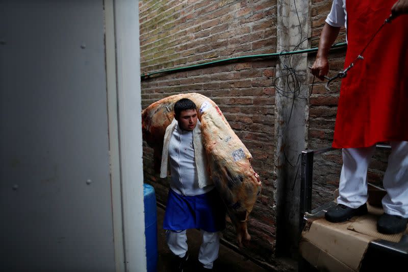 A butcher stores a cattle carcassin a butcher shop during the coronavirus disease (COVID-19), at wholesale food market Mercado Central (central market), in La Matanza, on the outskirts of Buenos Aires