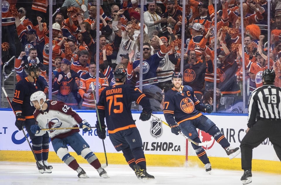 Edmonton Oilers center Connor McDavid (97) celebrates his goal against the Colorado Avalanche with left wing Evander Kane (91) and defenseman Evan Bouchard (75) during the first period of Game 3 of the NHL hockey Stanley Cup playoffs Western Conference finals, Saturday, June 4, 2022, in Edmonton, Alberta. (Jason Franson/The Canadian Press via AP)