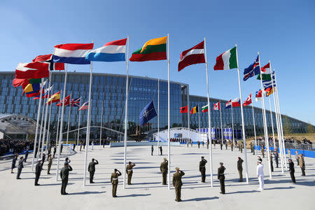 Flags of NATO member countires fly during a ceremony at the new NATO headquarters before the start of a summit in Brussels, Belgium, May 25, 2017. REUTERS/Christian Hartmann