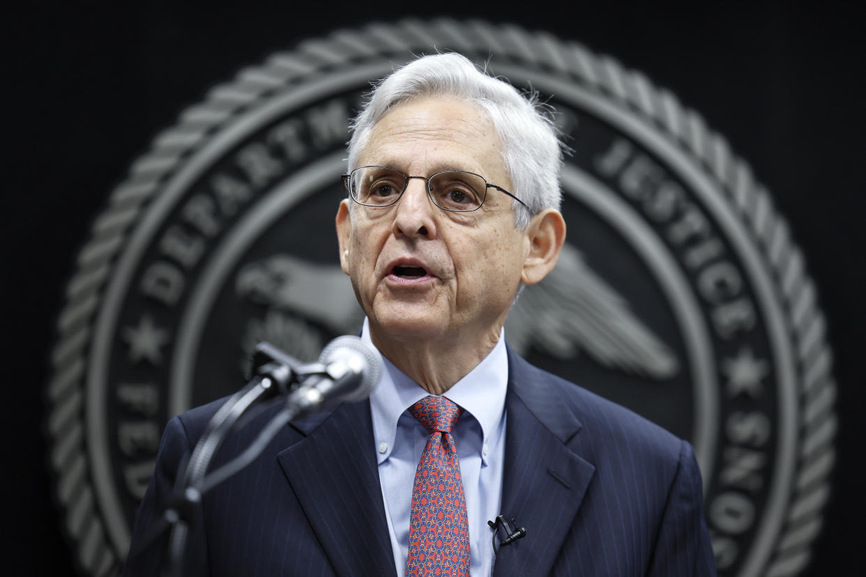 Merrick Garland speaks into a microphone.