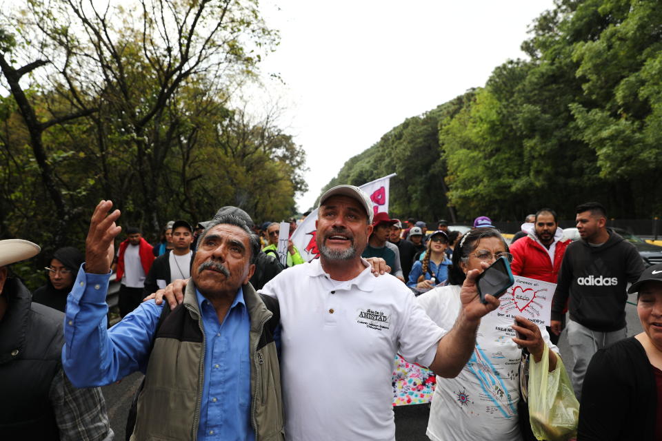 Adrian LeBaron, right, sings songs with a fellow protester as they attend a march against violence called "Walk for Peace" as the group leaves Cuernavaca, Mexico, Thursday, Jan. 23, 2020, with Mexico City as their destination. Activist and poet Javier Sicilia is leading his second march against violence in Mexico, this time accompanied by members of the LeBaron family, and plan to reach Mexico's National Palace on Sunday. (AP Photo/Eduardo Verdugo)