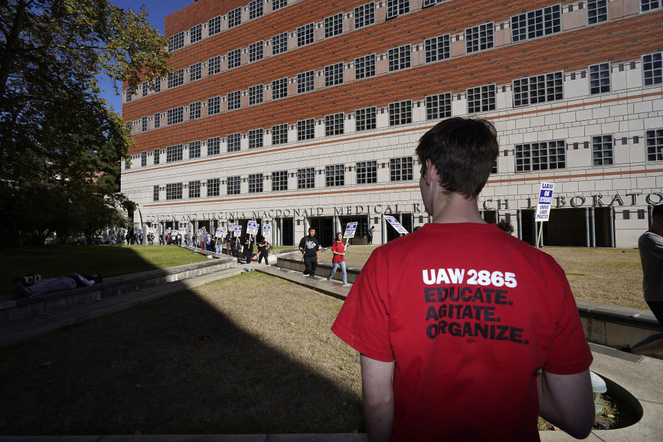 People participate in a protest outside of the University of California Los Angeles, UCLA campus in Los Angeles, Monday, Nov. 14, 2022. Nearly 48,000 unionized academic workers at all 10 University of California campuses have walked off the job Monday. (AP Photo/Damian Dovarganes)