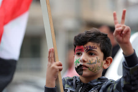 A Druze boy takes part in a rally over U.S. President Donald Trump's support for Israeli sovereignty over the Golan Heights, in Majdal Shams near the ceasefire line between Israel and Syria in the Israeli occupied Golan Heights March 23, 2019 REUTERS/Ammar Awad