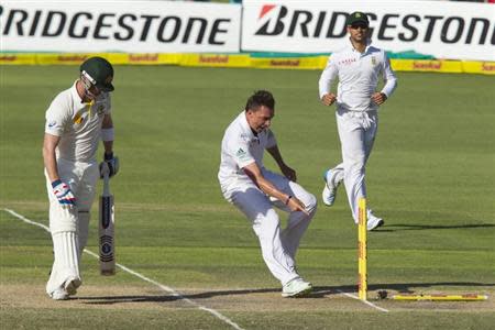 South Africa's Dale Steyn celebrates the wicket of Australia's Brad Haddin (L) with Robin Peterson looking on during the fourth day of the second cricket test match in Port Elizabeth, February 23, 2014. REUTERS/Rogan Ward