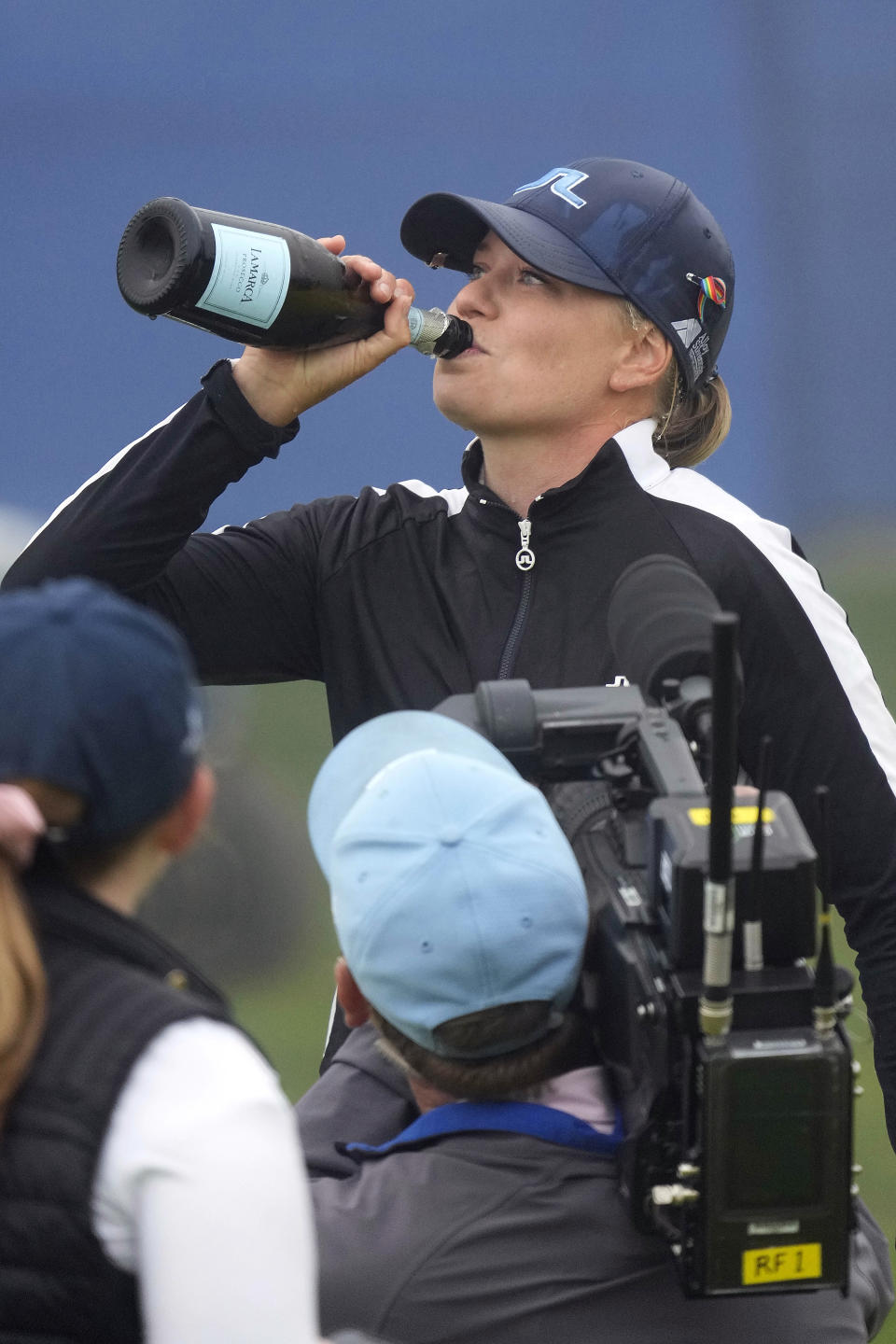 Matilda Castren, of Finland, drinks prosecco on the 18th green at the Lake Merced Golf Club after winning the LPGA Mediheal Championship golf tournament, Sunday, June 13, 2021, in Daly City, Calif. (AP Photo/Tony Avelar)