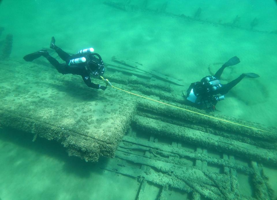 Divers take measurements on the remains of the Emerline, a 19th-century logging schooner in the water off Baileys Harbor that recently was placed on the State Register of Historic Places in Wisconsin.
