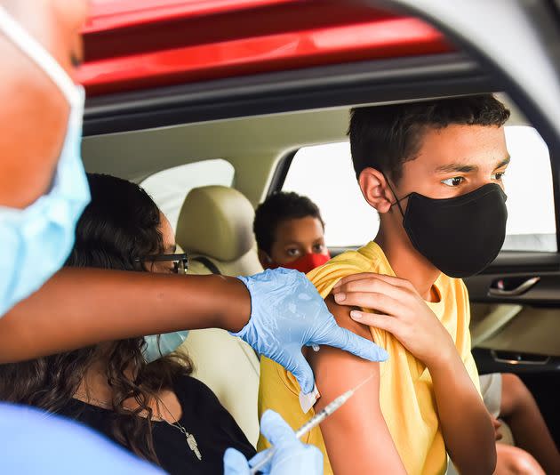 A nurse administers a COVID-19 vaccine to a kid at a drive-thru COVID-19 testing and vaccination site at Barnett Park in Orlando on Aug. 4.  (Photo: Paul Hennessy/SOPA Images via Getty Images)