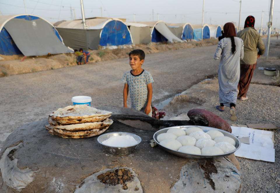 Displaced Iraqi family from Mosul bake bread for their Iftar, during the Muslim holy month of Ramadan at a refugee camp al-Khazir in the outskirts of Erbil, Iraq June 10.